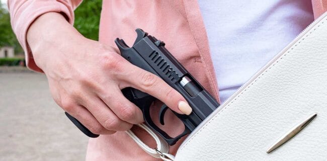 woman concealed carry semi-automatic 9mm pistol permit armed iStock-Evgen_Prozhyrko 1396427553