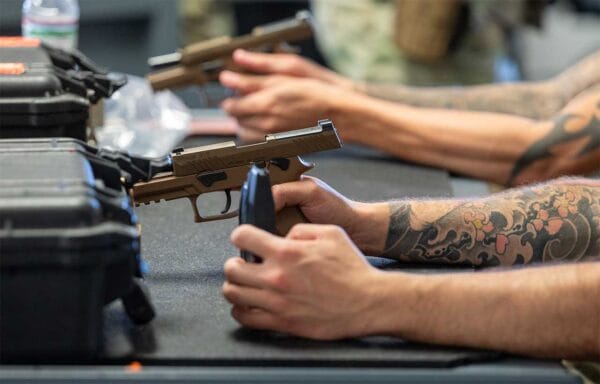 Combat Arms Training and Maintenance students learn how to properly handle M18 pistols at Holloman Air Force Base, New Mexico, July 3, 2025. (U.S. Air Force photo by Senior Airman Bob Teichmann)