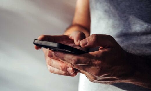 Man using modern smartphone iStock-BitsAndSplits 1989315506