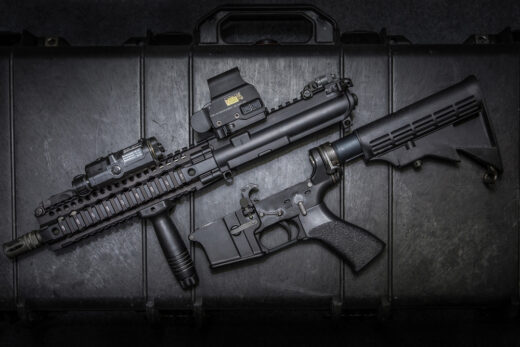 AR-15 style short-barreled rifle upper and lower receiver displayed on a hard case