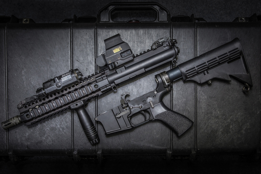 AR-15 style short-barreled rifle upper and lower receiver displayed on a hard case