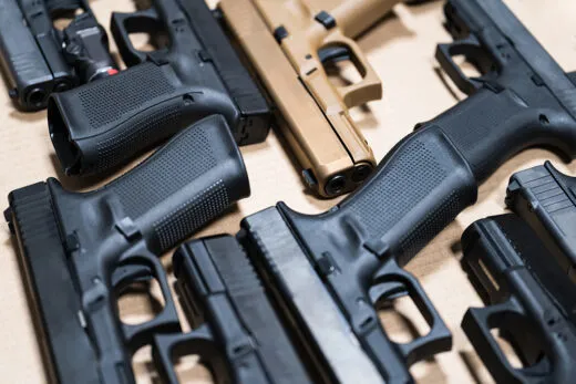 9mm pistols arranged on a counter of a home-based gun store.