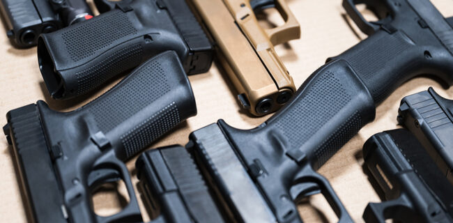 9mm pistols arranged on a counter of a home-based gun store.