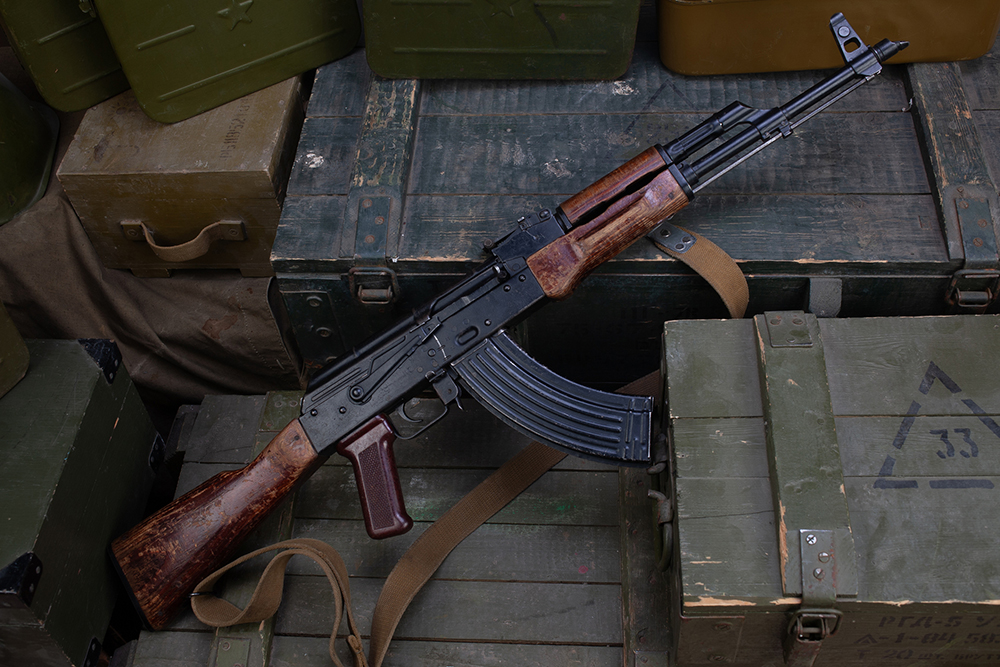 Kalashnikov AK 47 with ammunitions on army green box background