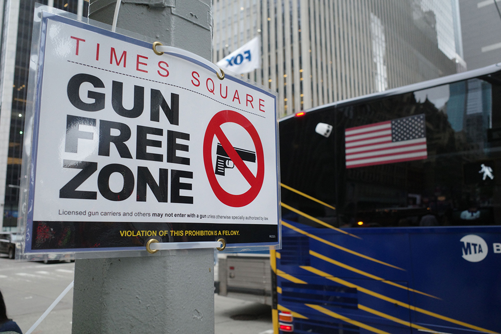 Gun free zone sign in Times Square in New York City iStock-1442914010