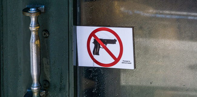 No-guns sign posted on a public transit door in Illinois