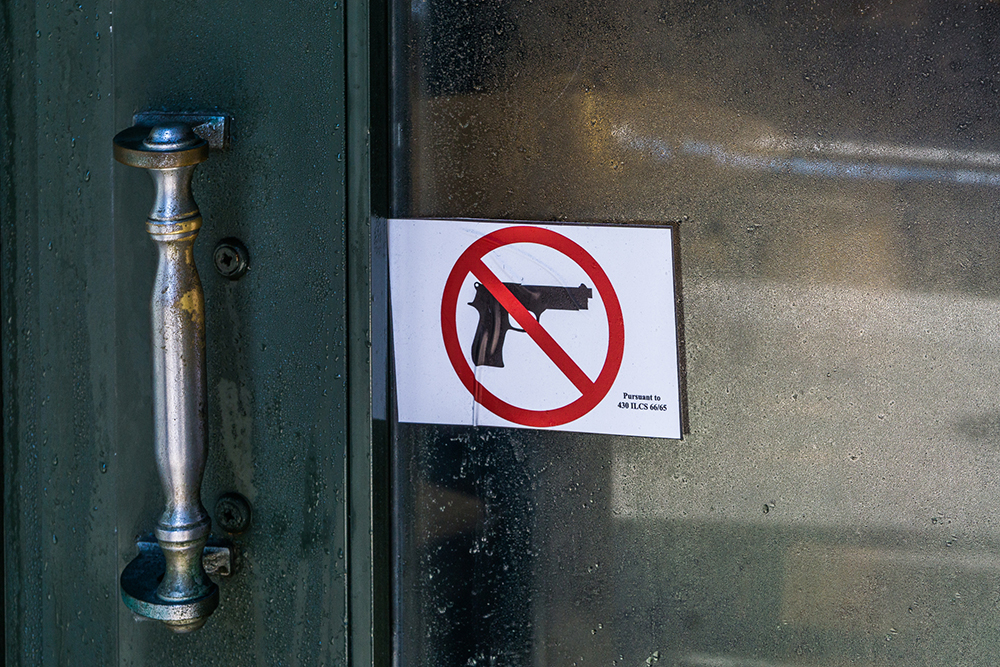 No-guns sign posted on a public transit door in Illinois