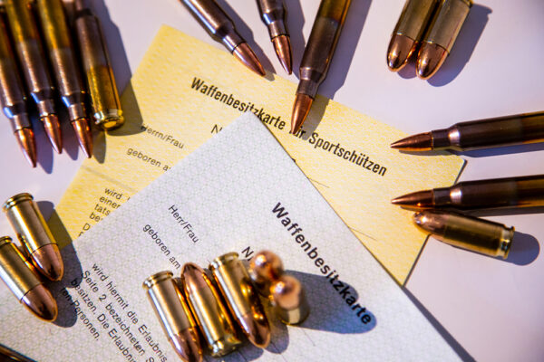 German ‘Waffenbesitzkarte für Sportschützen,’ a firearms possession card for sport shooters, shown with ammunition for handguns and long guns. iStock-1208764235