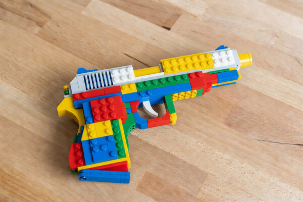 LEGO handgun toy image generated by Grok Imagine, an AI model from xAI.