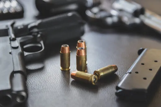 .45 Caliber hollow point bullets near handgun and magazine stock photo iStock.com/[Pratchaya]