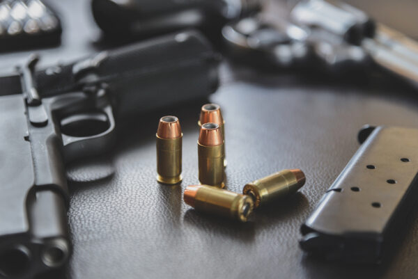 .45 Caliber hollow point bullets near handgun and magazine stock photo iStock.com/[Pratchaya]