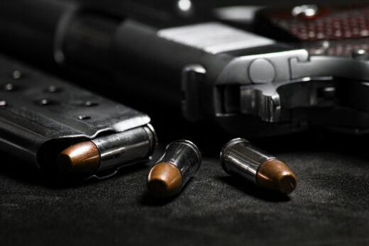 1911-style semi-automatic pistol and hollow point ammo. iStock.com/[SyncRapeephat]