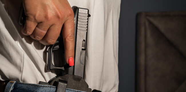 Armed woman protects her husband during a home-defense encounter iStock.com/[Dmitri Toms]