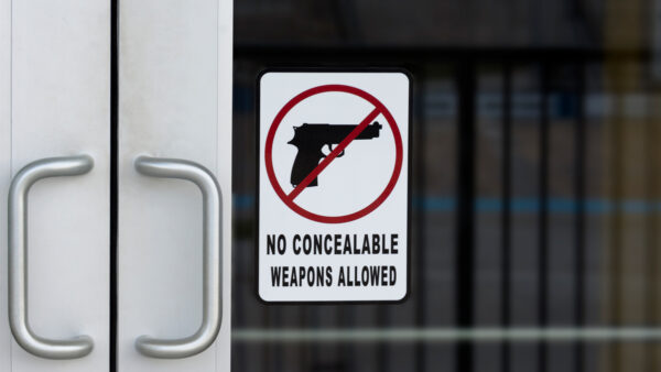 Hawaii Firearms Coalition urges Hawaii businesses to reconsider posting "No Firearms Allowed" signs after the Supreme Court's Wolford decision. iStock-1453704487